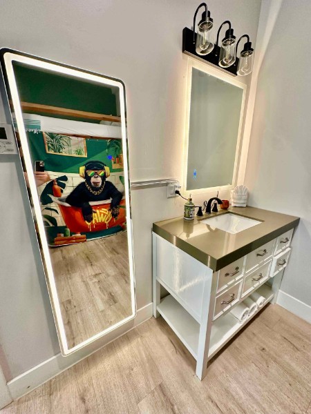 Bathroom with full-length mirror and vanity