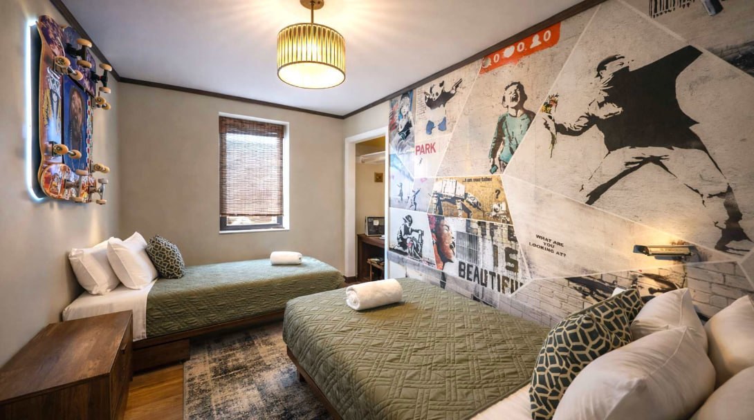 Bedroom with street art mural wall and twin beds