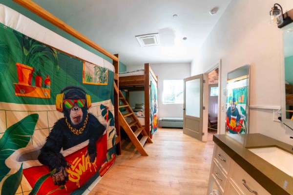 Bunk room with gorilla mural and wood bunks