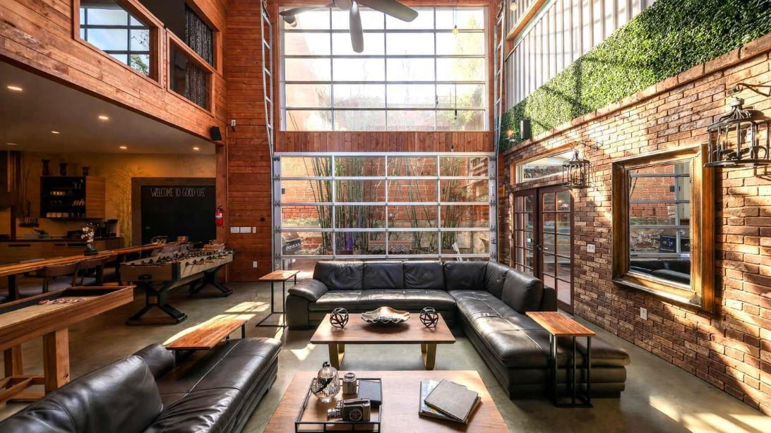 Main lounge with leather sectionals, foosball, and floor-to-ceiling windows