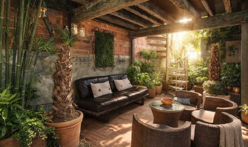 Covered patio with plants and lounge seating